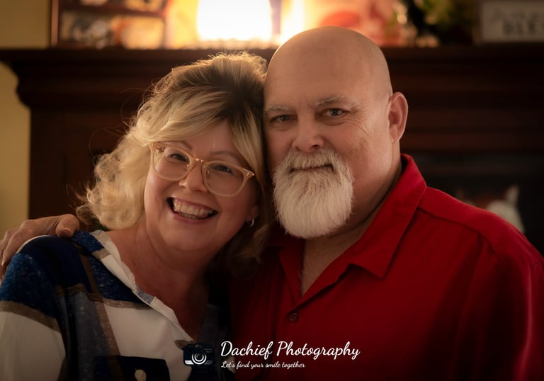 A smiling senior couple posing for a professional portrait by Dachief Photography. Athens, Oh