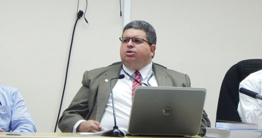 a judge in a suit and tie is sitting at a table