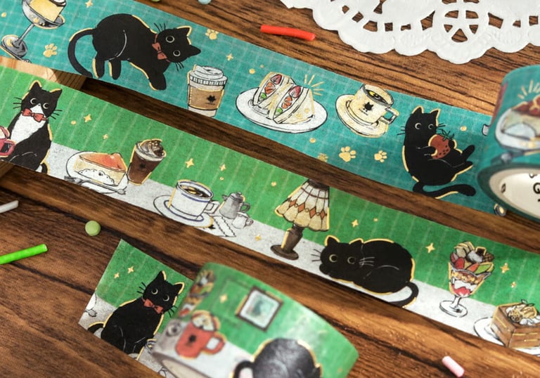 Green decorative washi tape featuring illustrations of black cats and cafe food for scrapbooking.