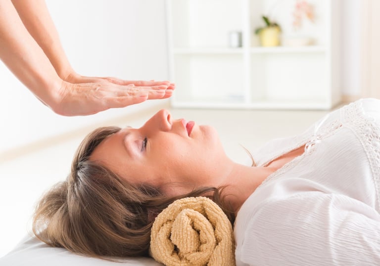 a woman is shown in a massage room sesiones de reiki