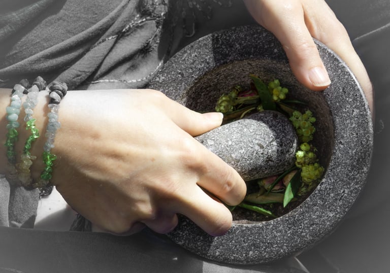 a person holding a mortar and pestle grinding herbs