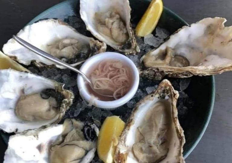 Oysters served to wedding guests on a bed of ice with shallot mignonette