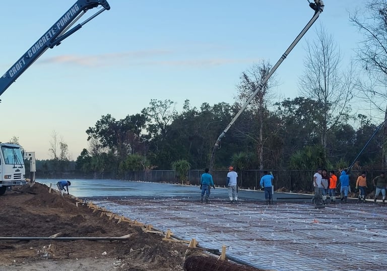 Croft Concrete boom truck and workers on a constuction site .