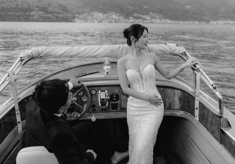 a bride and groom on a boat in a lake como