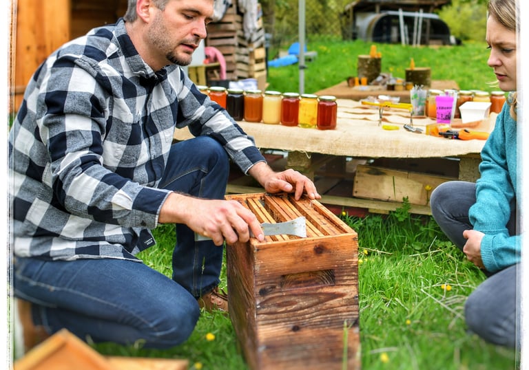 a man and woman sitting on a picnic table