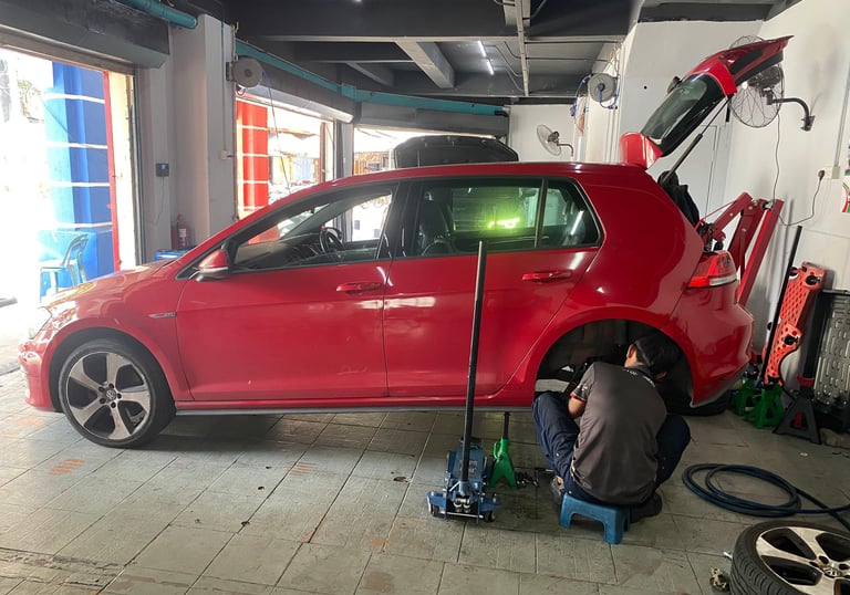 a man working on a car in a garage