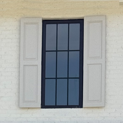 Fixed exterior shutters on a brick home