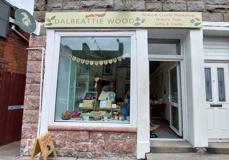 Dalbeattie Wood shop front showing shop window open door and shop sign above with squirrel logos