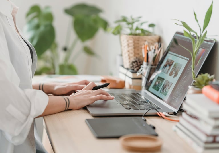 woman sitting at desk working on her laptop