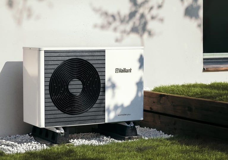 A Vaillant aroTHERM plus air source heat pump installed outdoors on a gravel base for efficient home heating.