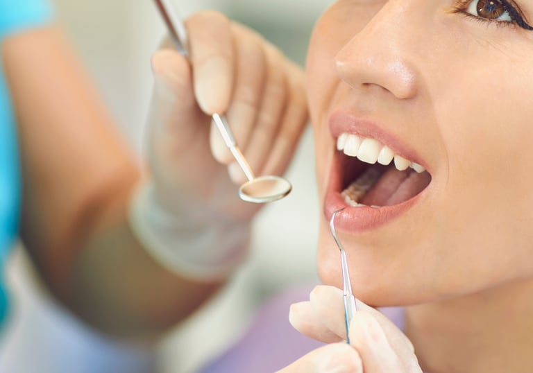 Dentist applying a tooth filling to restore a decayed tooth, showcasing a restorative dental procedu
