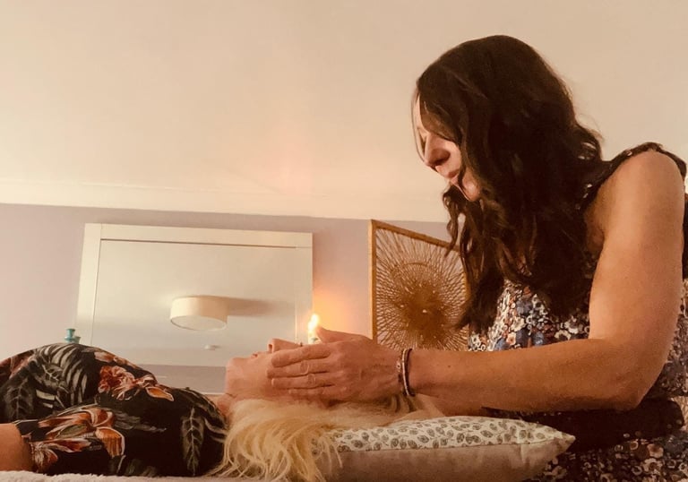 Liv giving reiki to a lady; her hands around her head