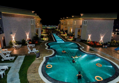 a pool with people swimming in the water