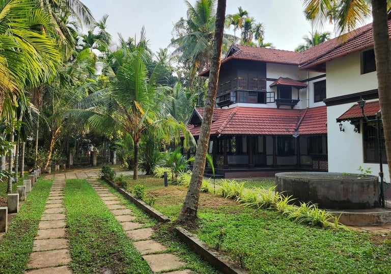 Exterior image of Poomuttath Illam with its greenery and pathway