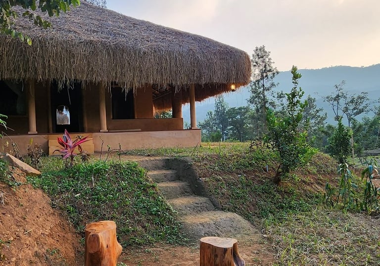 A mud house in Nelli looking at brahmagiri mountains
