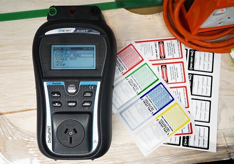 a test and tag machine on a table with tags 