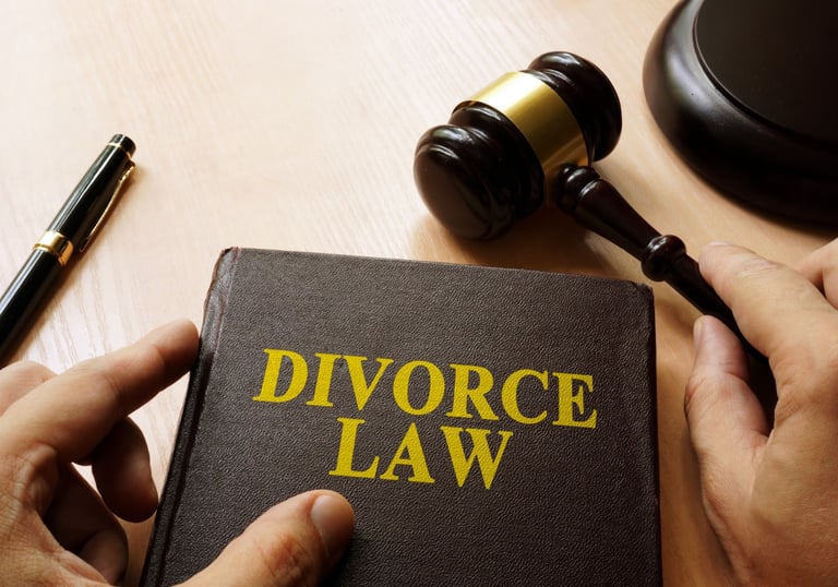 A divorce law book with pen and gravel