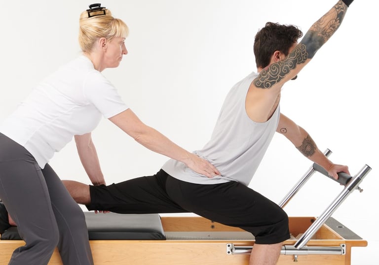 a woman coaching a client on the reformer
