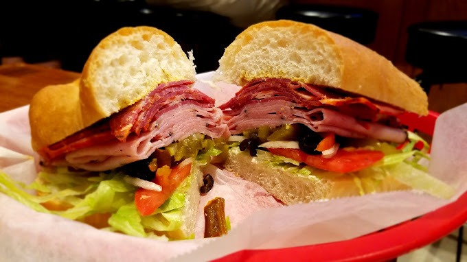 a Hogans Great Sandwich with meat and vegetables on a basket