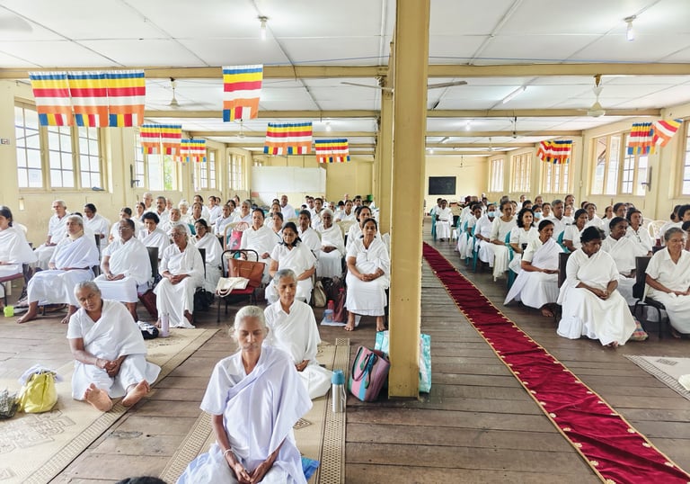 a group of people sitting in a room with many people