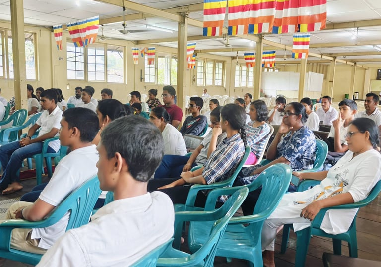 a group of people sitting in chairs in a room for meditation