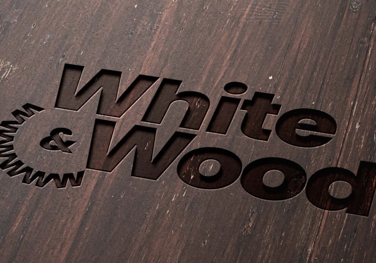Engraved logo on wood surface of White and Wood Custom Carpentry