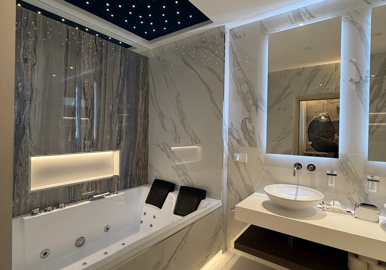 a bathroom with a tub tub and a large mirror