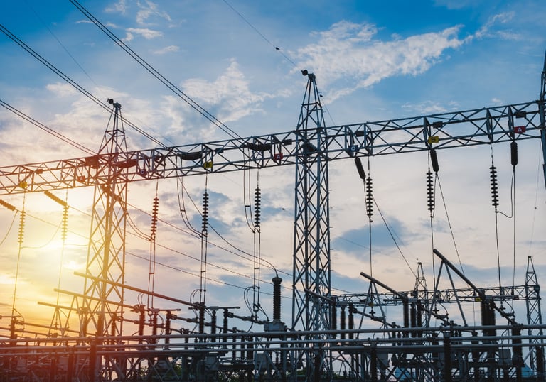 A picture of industrial power lines with a beautiful sunset in central texas