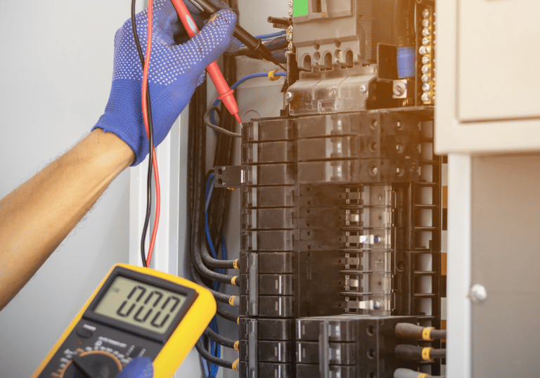 An electrician in Bangs testing the electric panel at the home of a customer