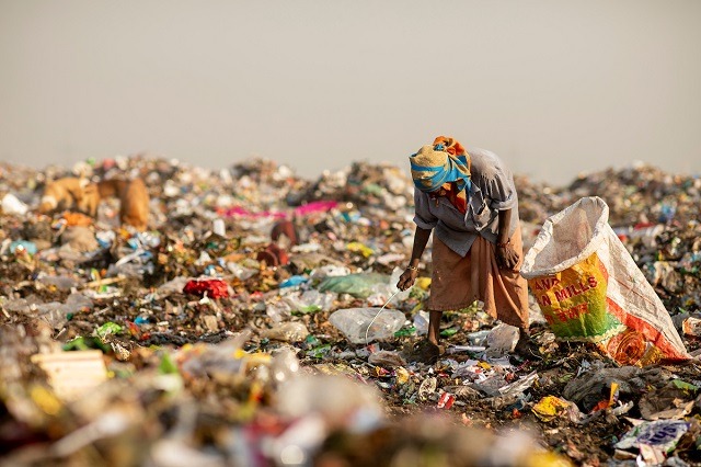 garbage collected picking plastic trash from a hazardous dumpsite in kenya
