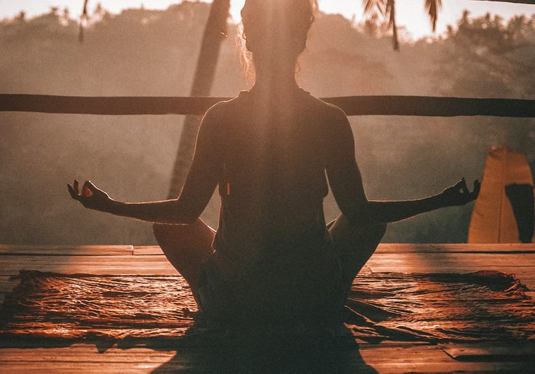 woman meditating in lotus pose in the sun