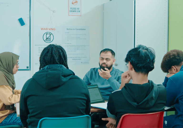 Dedicated tutor teaching students Excel skills for entrance exam preparation
