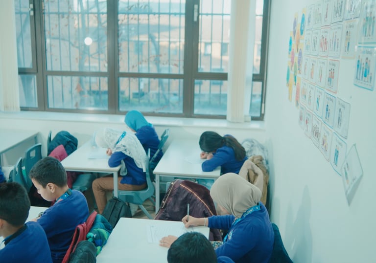 Students receiving guidance from a tutor at a private exam centre for Excel certification.