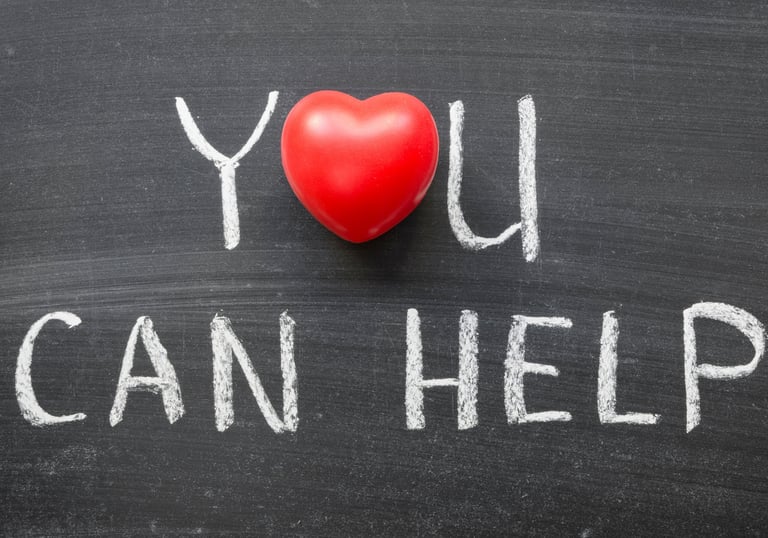 a red heart on a chalkboard with the words you can help