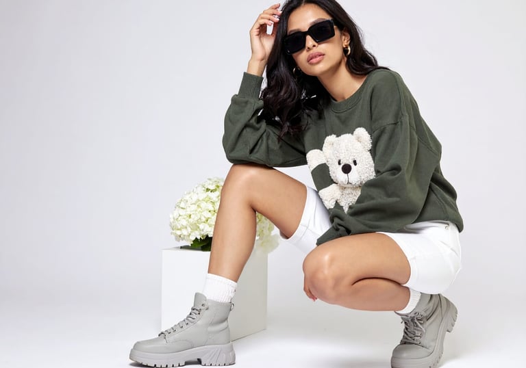 a woman in a green sweater and white sneakers