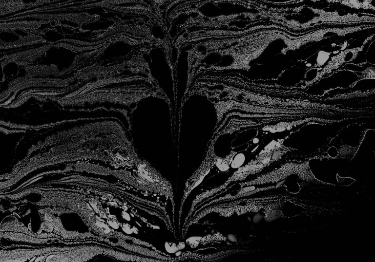 A bleeding heart found emerging from formed and swirling ink on water