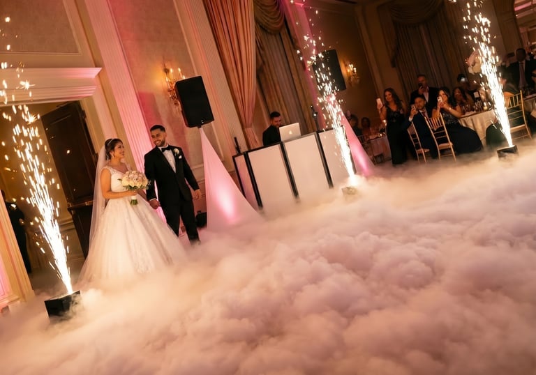 Bride and groom dancing on a cloud with indoor sparklers at a luxury wedding reception.
