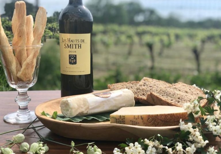 a bottle of wine and breadstickers on a table