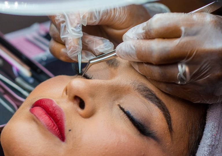 a woman getting her eyebrows done by a professional hairdresser