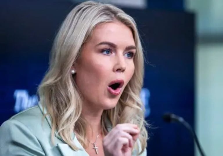 a woman in a green jacket and a microphone