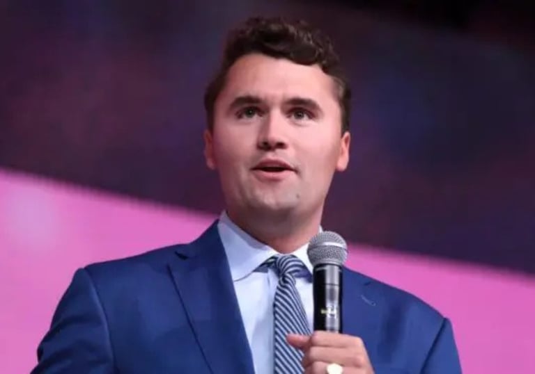 a man in a blue suit and tie is holding a microphone