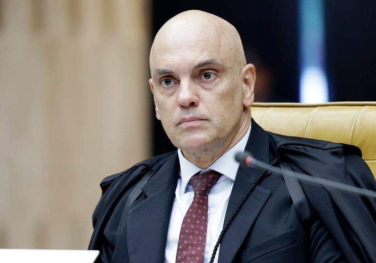 a man in a suit and tie sitting in a chair