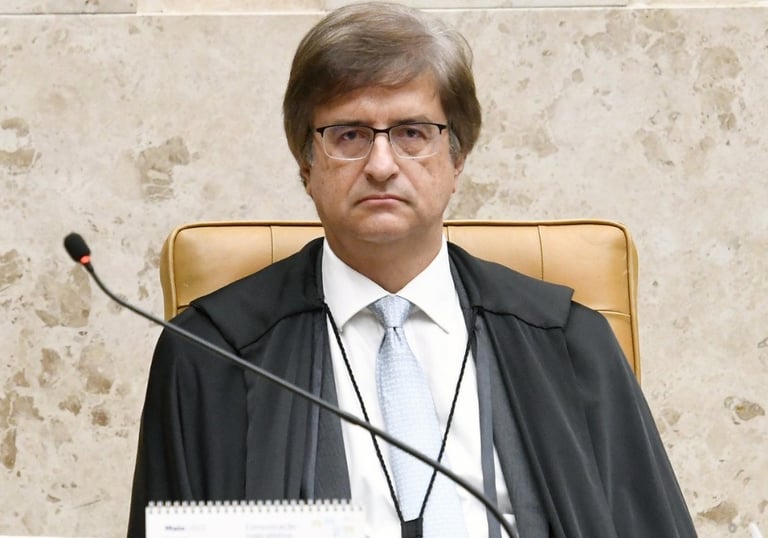 a man in a suit and tie is sitting at a desk