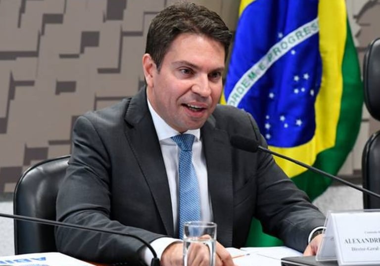 a man in a suit and tie is sitting at a table