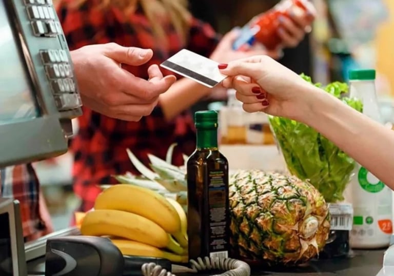 a person is paying a purchase at a grocery store