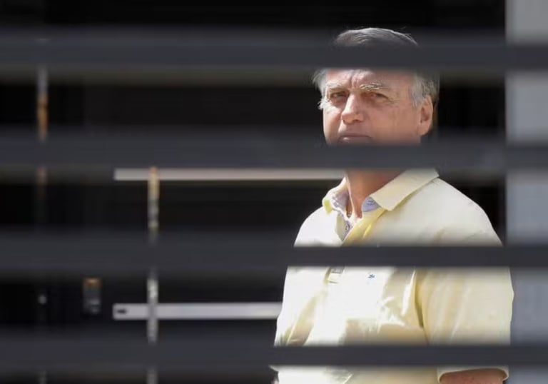 a man in a yellow shirt and tie dyes a tie