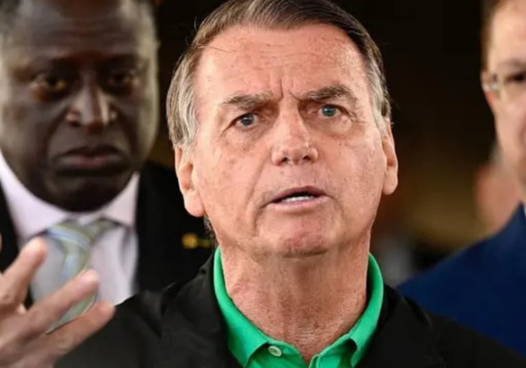 a man in a suit and tie is talking to a reporter