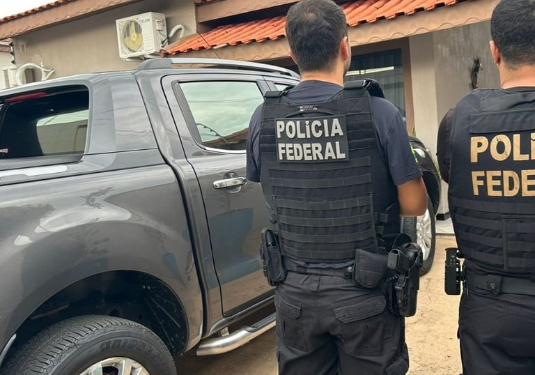 two police officers standing in front of a truck