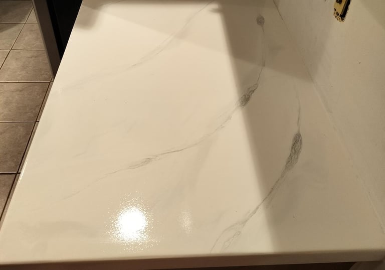 Custom white epoxy countertop with marble-style veining – seamless, glossy finish ideal for kitchens