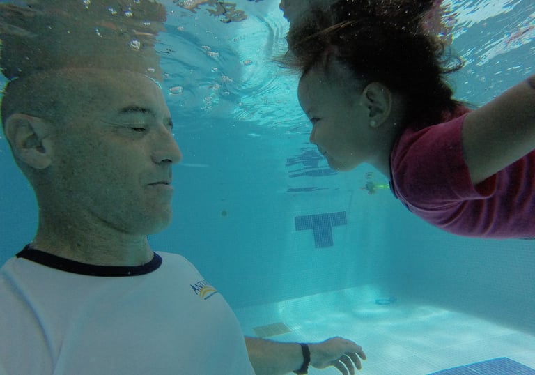 a man and a woman swimming in a pool